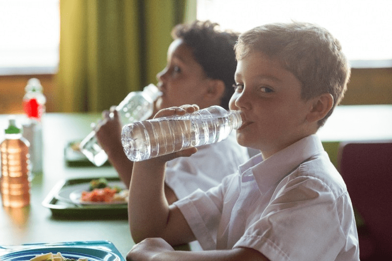 Student drinking water emphasizing simple habits that support good health