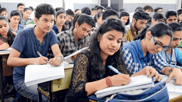 Indian student studying late night at desk showing hard work and discipline