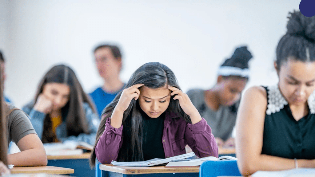 Stressed Indian student studying quietly without giving up on academic goals