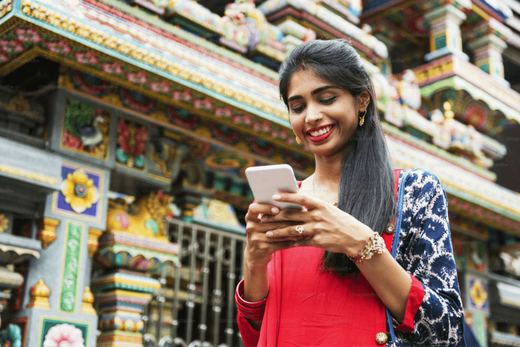 Indian person holding phone thoughtfully representing meaningful motivation bio identity